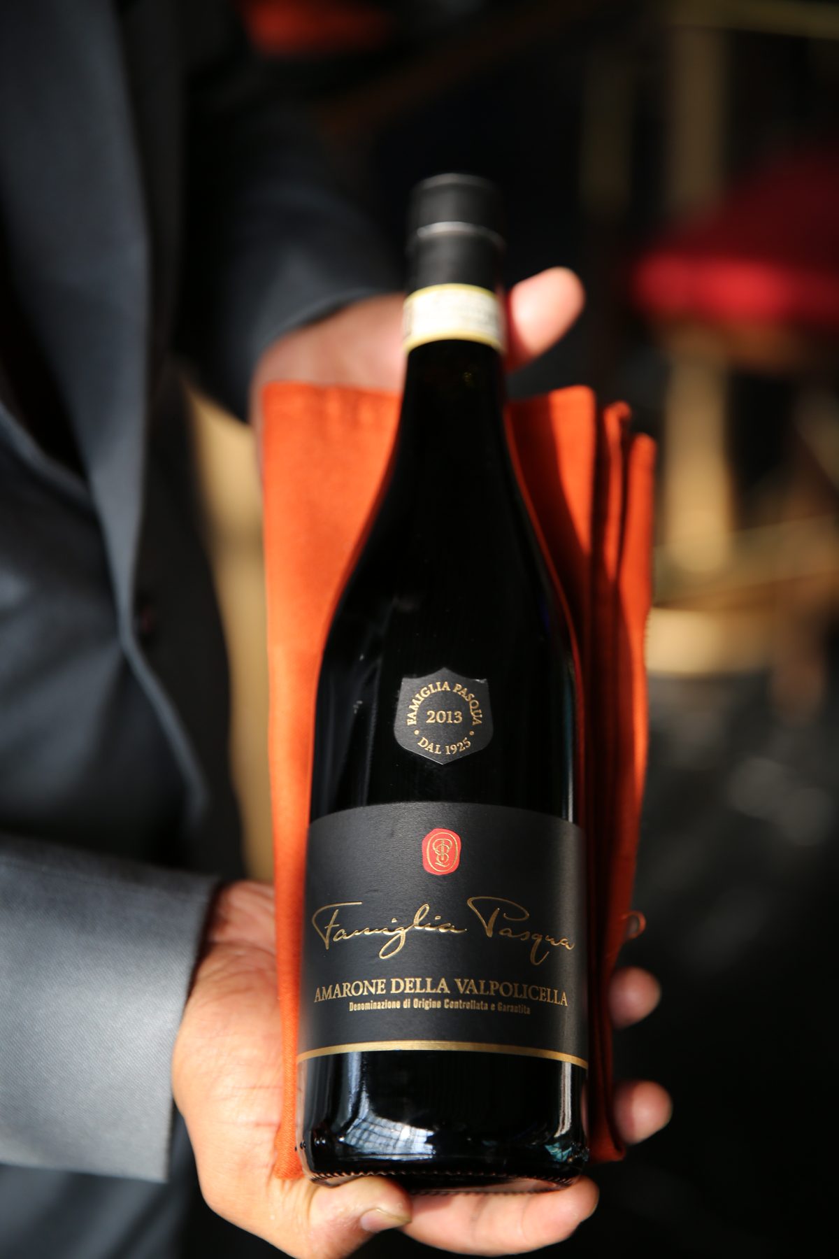 Bottle of Amarone presented by a server