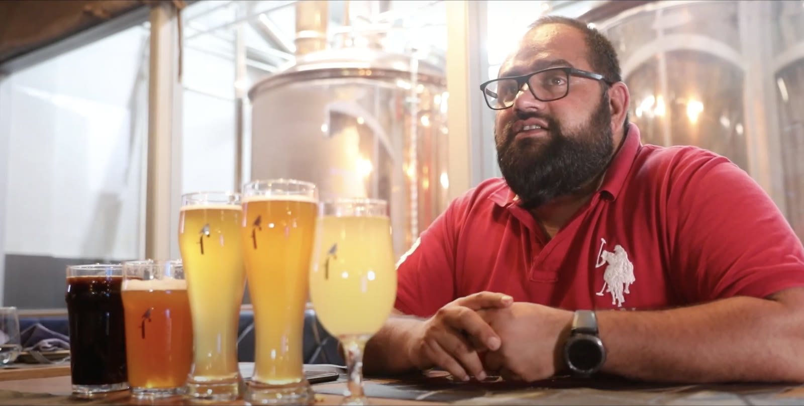 Brewmaster at a table with a flight of craft beers